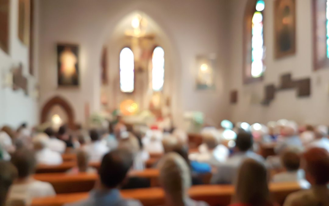 Blurred photo of praying people in the church for abstract background